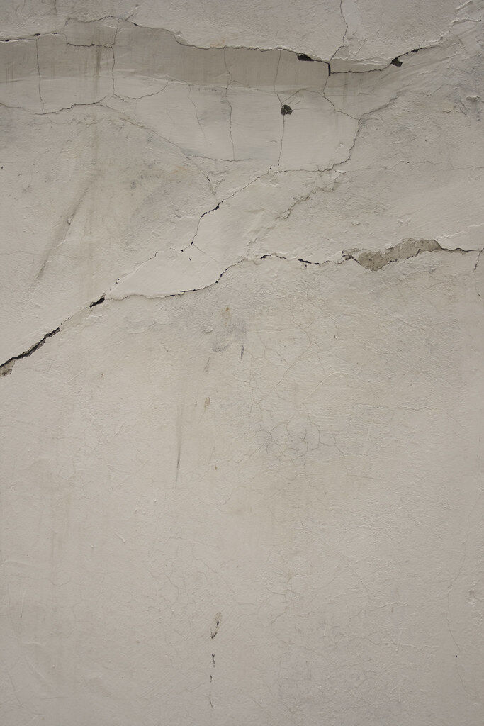 Cracked plaster wall, shown as an example of the interior cracking that foundation movement causes